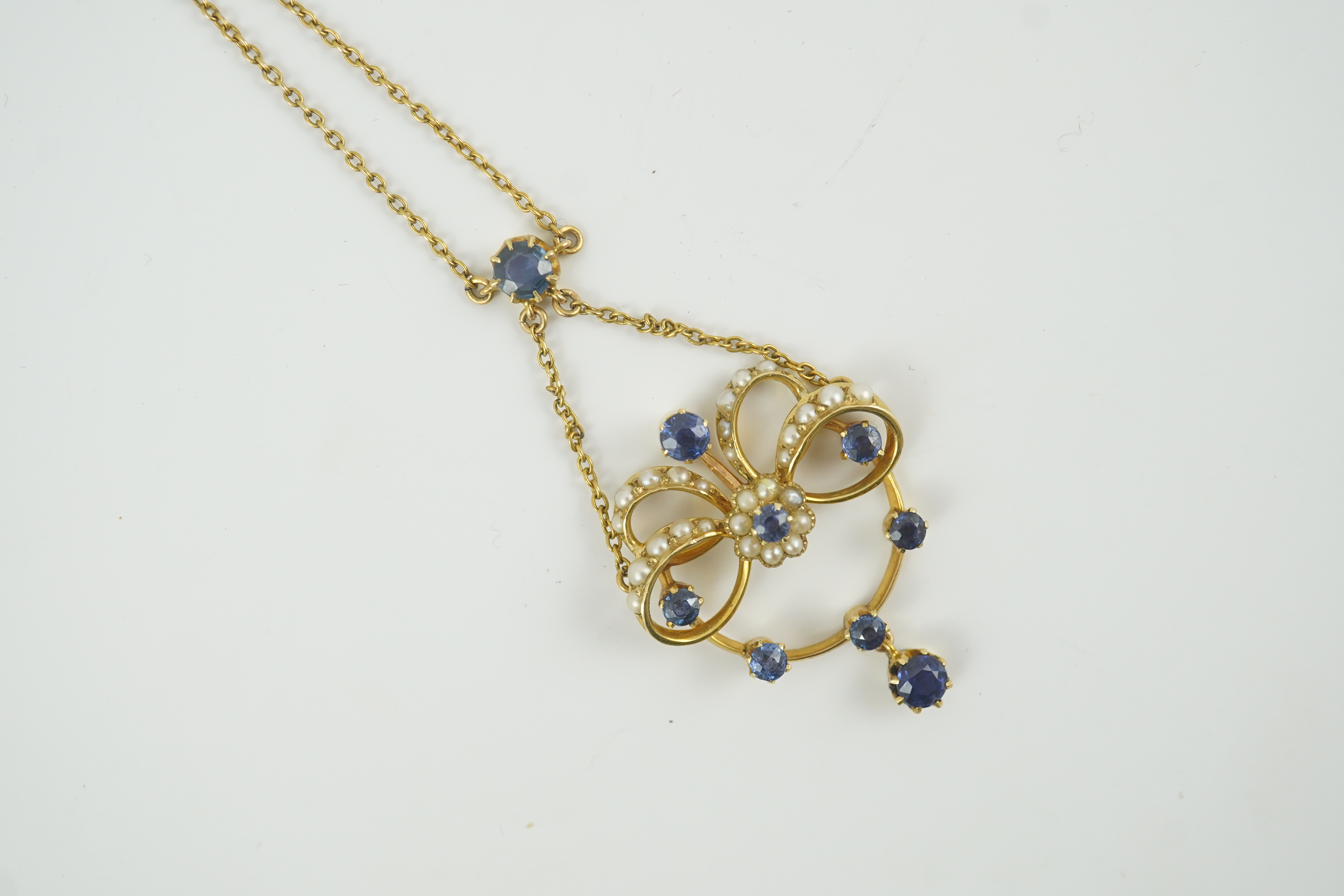 A mid 20th century gold, sapphire and seed pearl cluster set drop pendant necklace